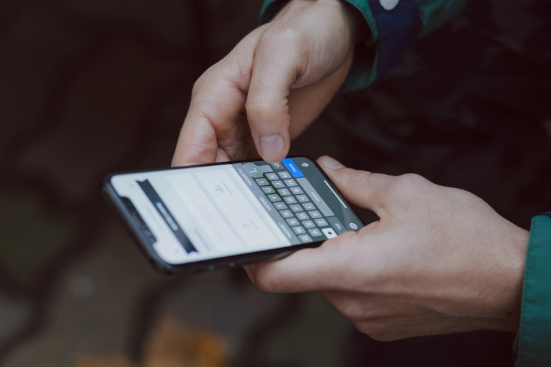 Optimizing Your Website for Voice Search : A man holding a cell phone 