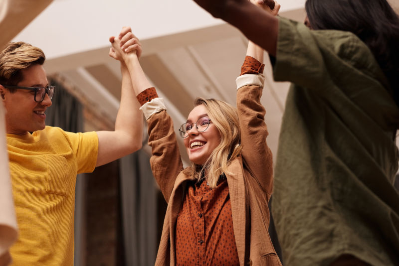 Popular SEO Tools : Image of people raising hands together in cheering